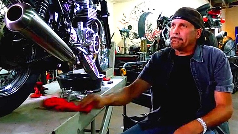 Robbie Knievel sitting in a motorcycle shop