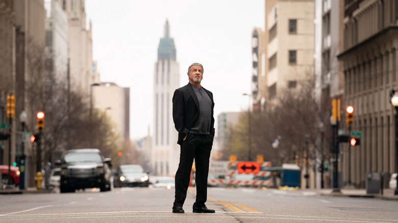 Dwight Manfredi wearing black standing in the street