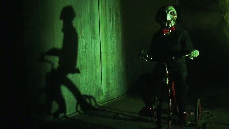 Billy the Puppet riding tricycle