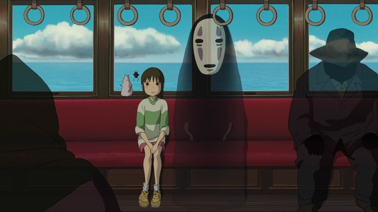 Chihiro and No Face sit on train