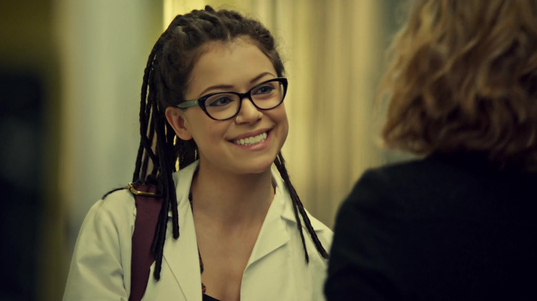 Cosima grinning at Delphine in lab coat