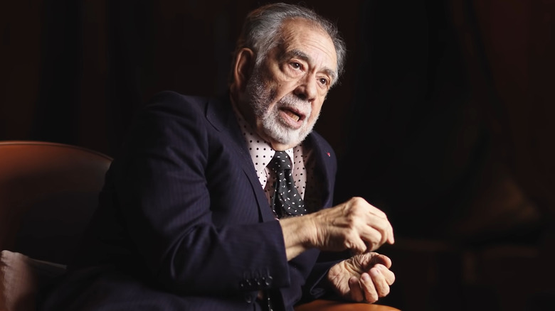 Francis Ford Coppola talking and sitting