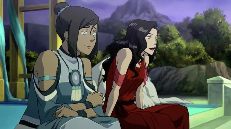 Korra sits next to Asami