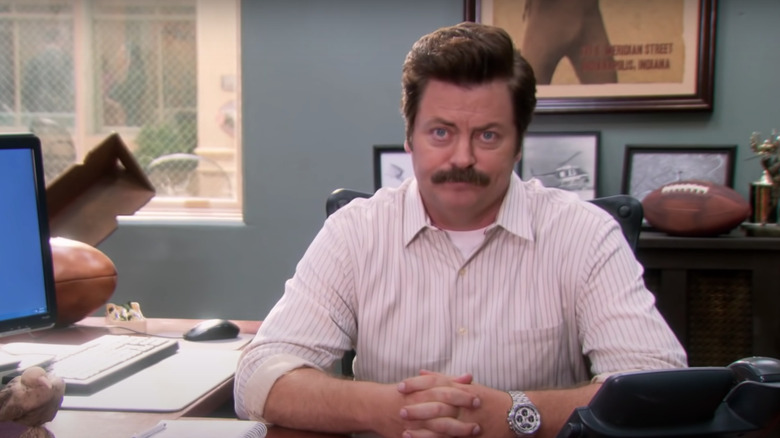 Ron Swanson sitting at desk