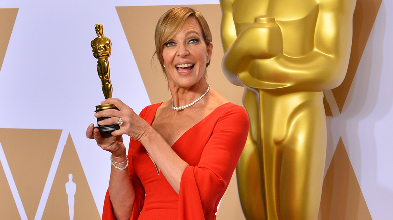 Allison Janney in red dress posing with Oscar award 