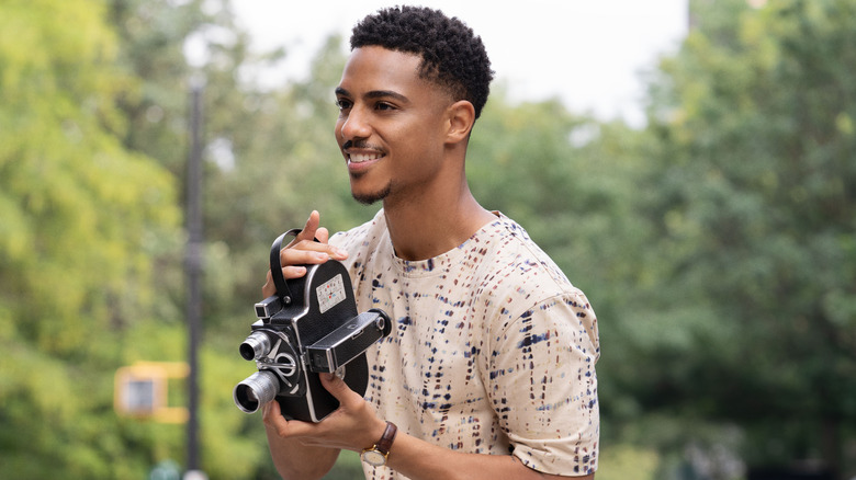 Eric smiling and holding camera