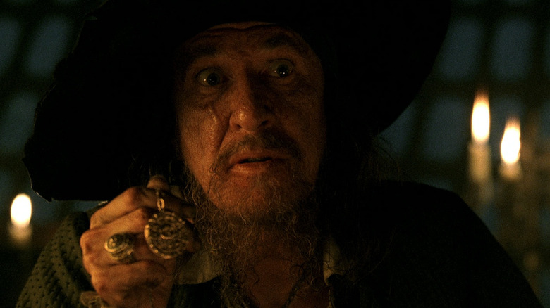 Pirates of the Caribbean Barbossa holds a gold medallion