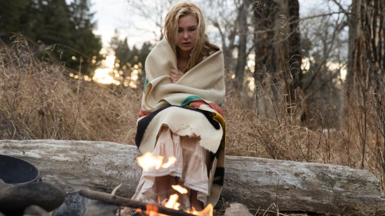 Elsa Dutton sitting by a fire with a Point Blanket