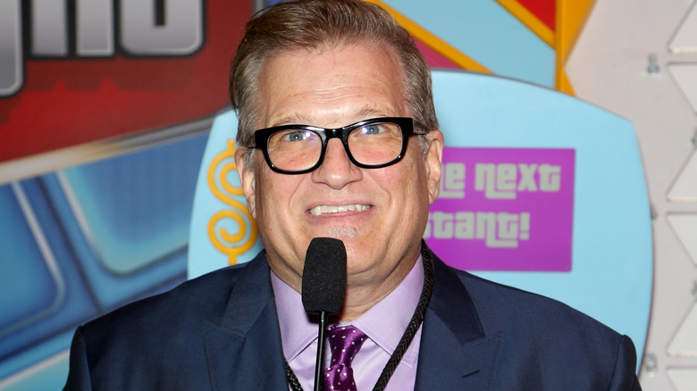 Drew Carey smiling at event wearing a suit