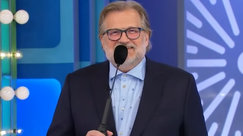 Drew Carey holding a microphone