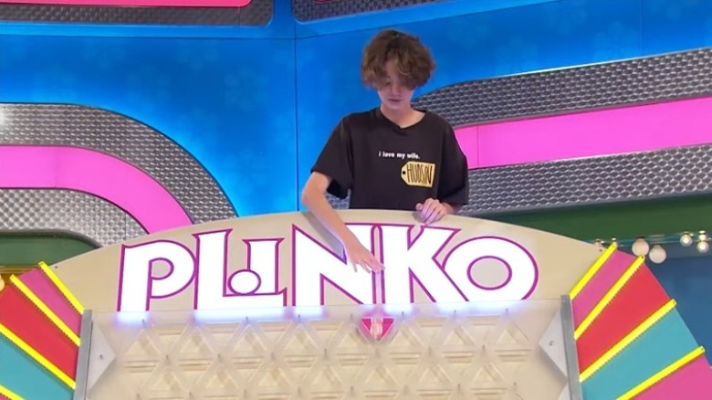 A contestant playing Plinko