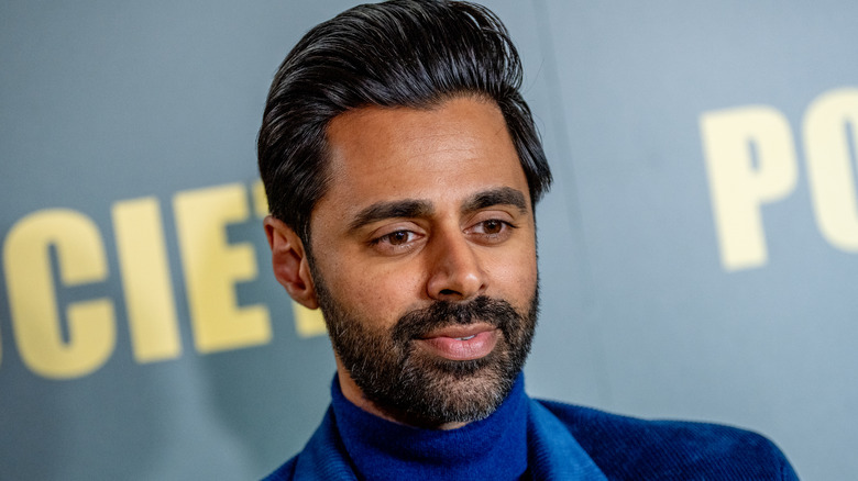 Hasan Minhaj smiles for photos