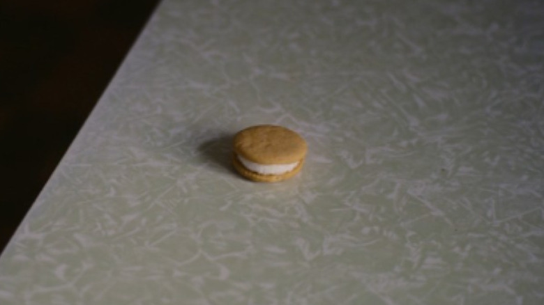 A sandwich cookie sits on a kitchen table in "The Quiet Girl" (2023)