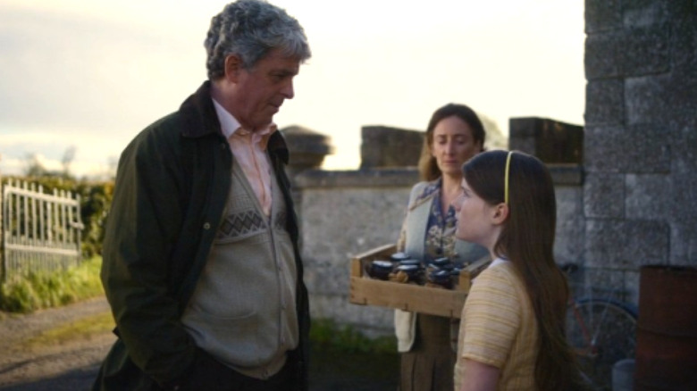 Seán and Cáit look at each other with Mam behind them in "The Quiet Girl"