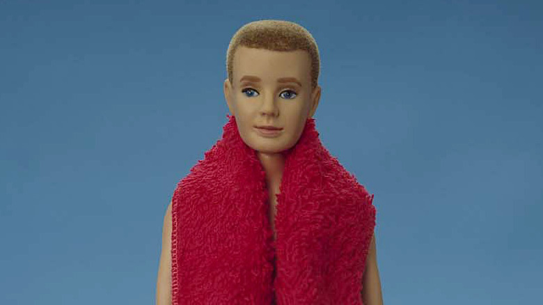 The original Ken doll posed outside of its packaging