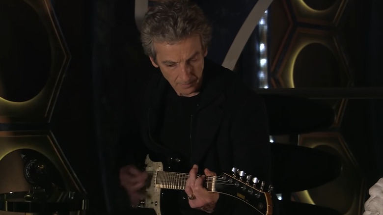 Twelfth Doctor playing guitar