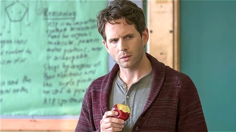 Jack eating an apple in front of a chalkboard in "A.P. Bio"