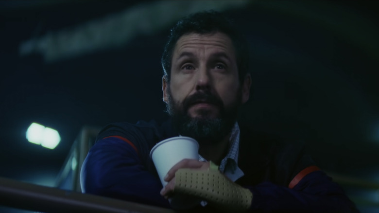 Adam Sandler looking sad with cup in Hustle