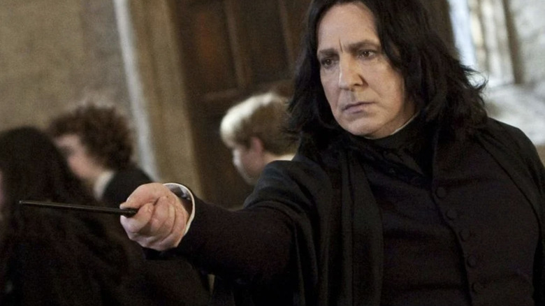 Alan Rickman as Snape holding wand