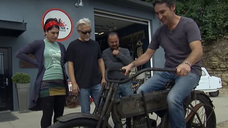 Mike Wolfe on a motorcycle with the American Pickers cast