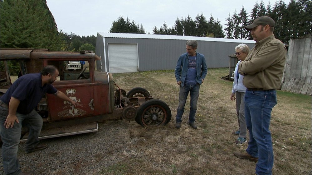 Mike Wolfe and Frank Fritz examine an old-timey vehicle on American Pickers