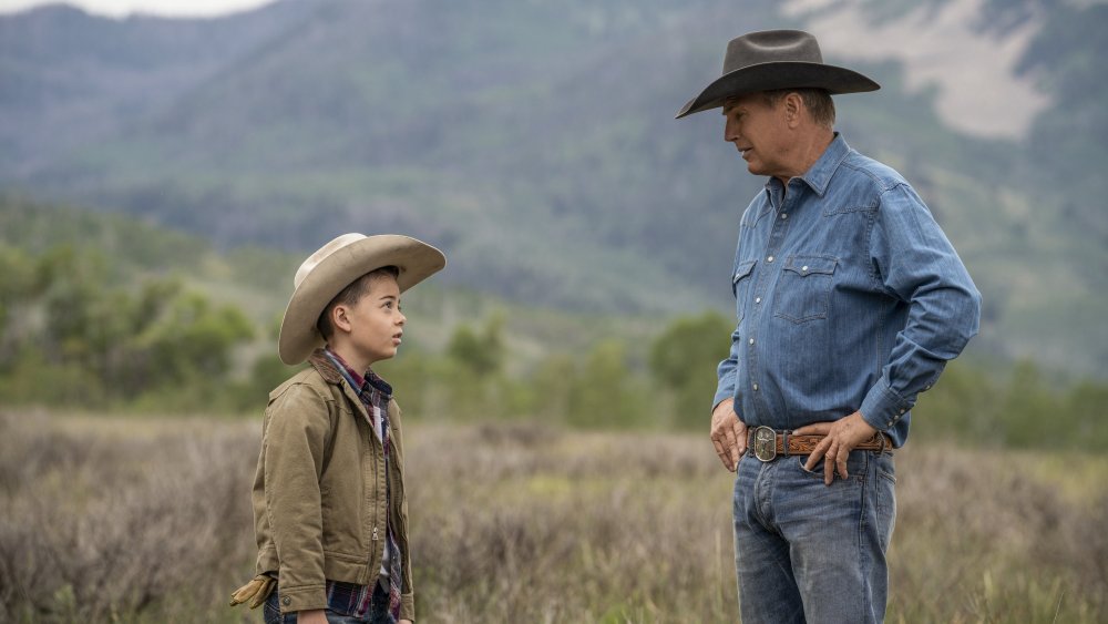 John Dutton (Kevin Costner) talks to his grandson (Brecken Merrill) on Yellowstone
