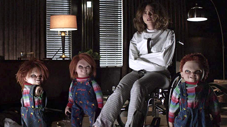 Fiona Dourif straightjacket with three Chucky dolls