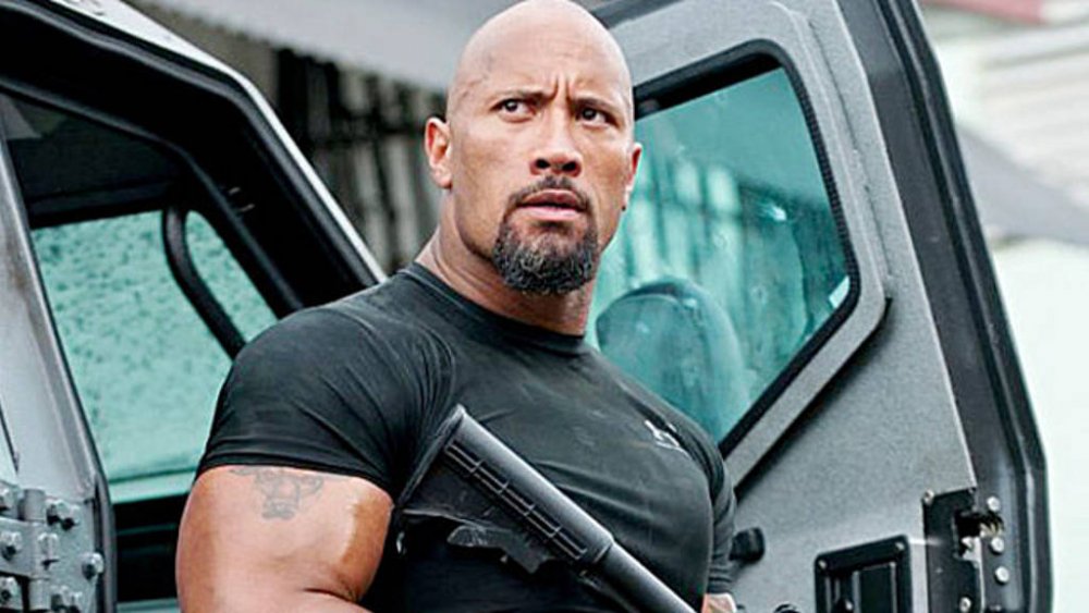 Dwayne Johnson Luke Hobbs standing outside car