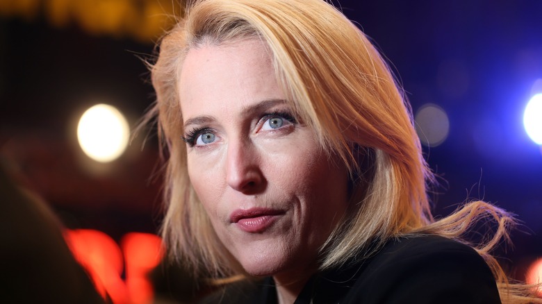 Gillian Anderson with blond hair looking up