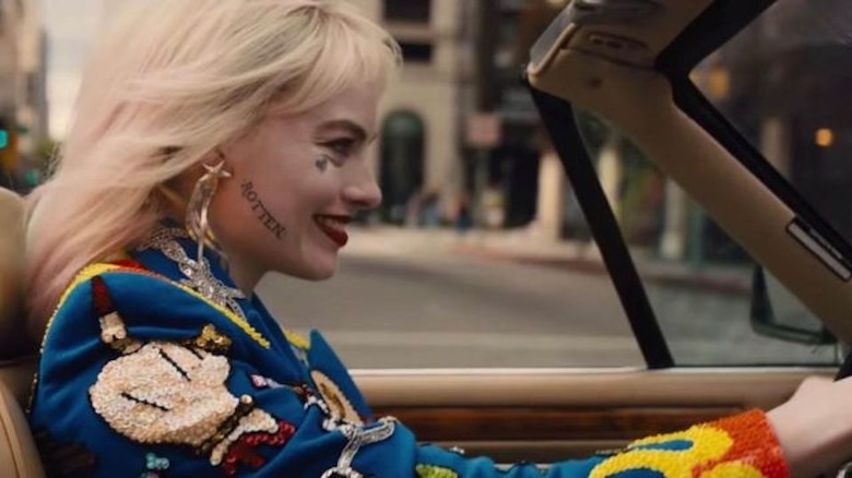 Harley Quinn driving and smiling