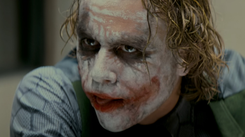 Heath Ledger licks his lips as the Joker in The Dark Knight