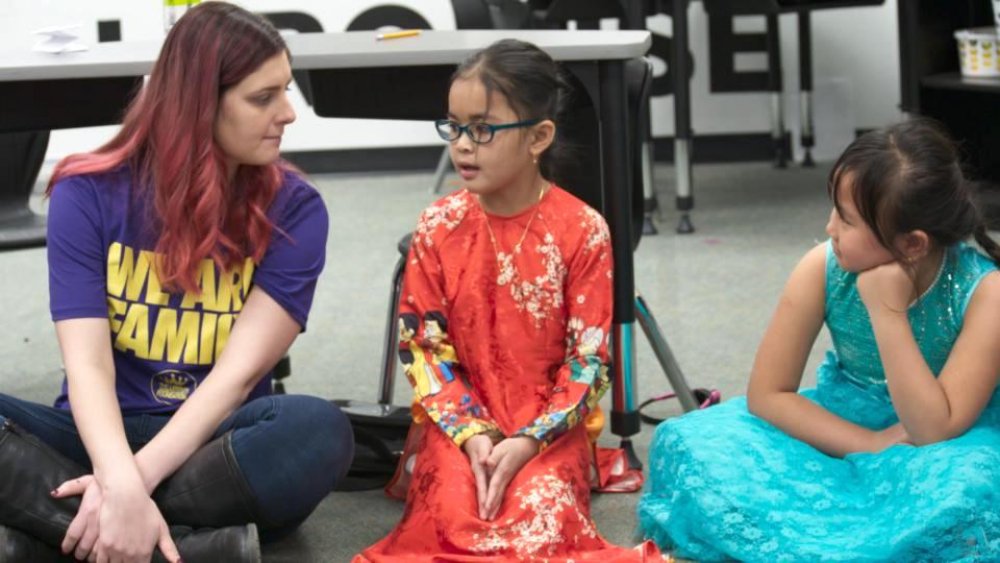 A teacher at the I Promise School talks with two students in the "Trust" episode