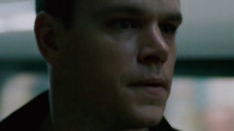 A weary Jason Bourne scans for danger.