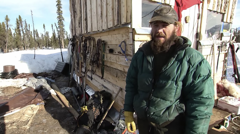 Morgan Beasley standing outside his tiny homestead