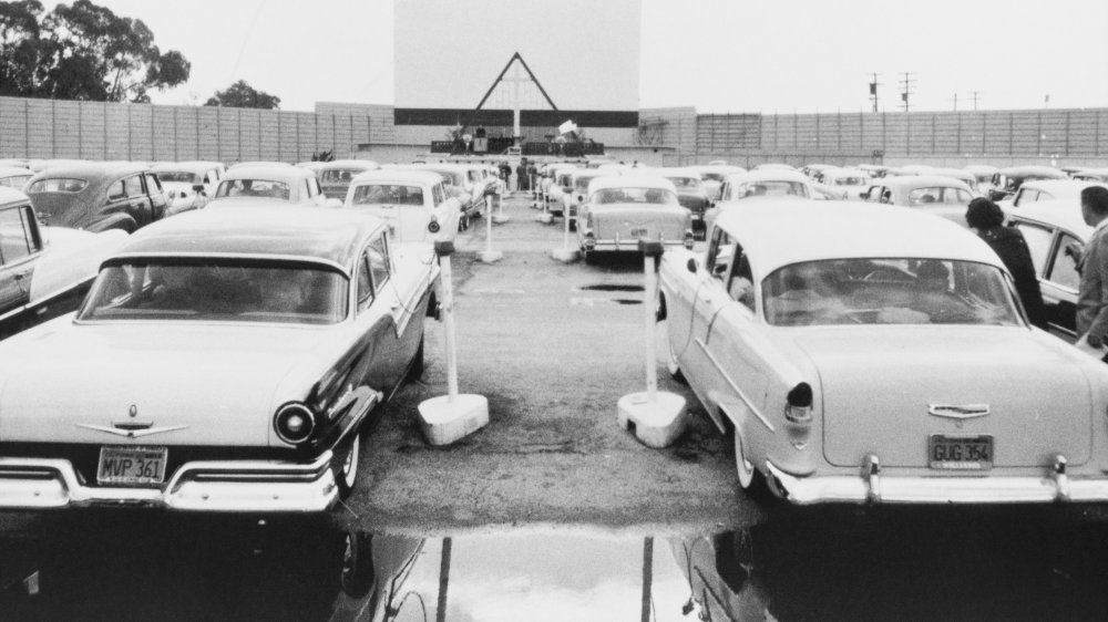 a vintage photo of classic cars at a drive-in