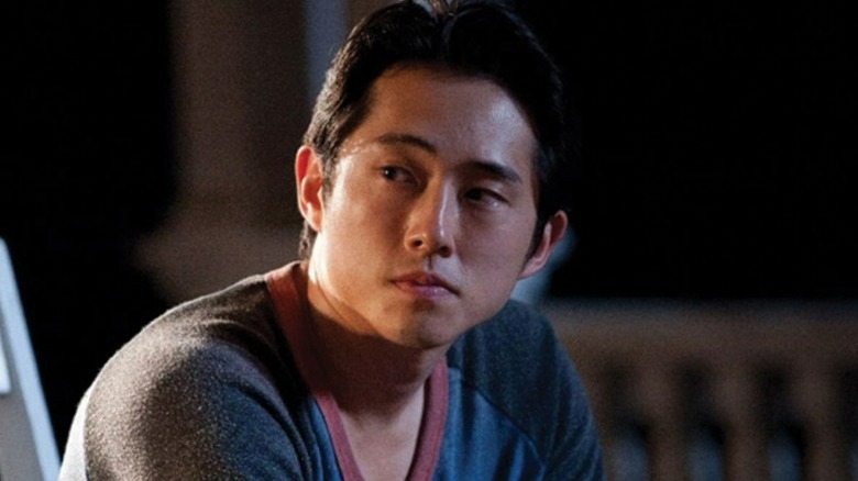 Glenn Rhee sitting on a porch