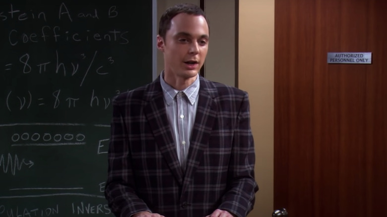 Sheldon Cooper standing in front of a blackboard