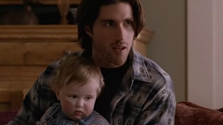 Matthew Fox holding one of the babies that played Owen Salinger in "Party of Five"