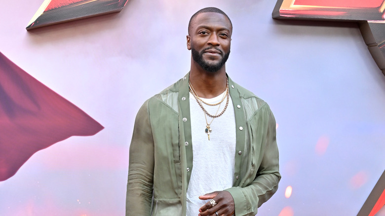 Aldis Hodge in green shirt