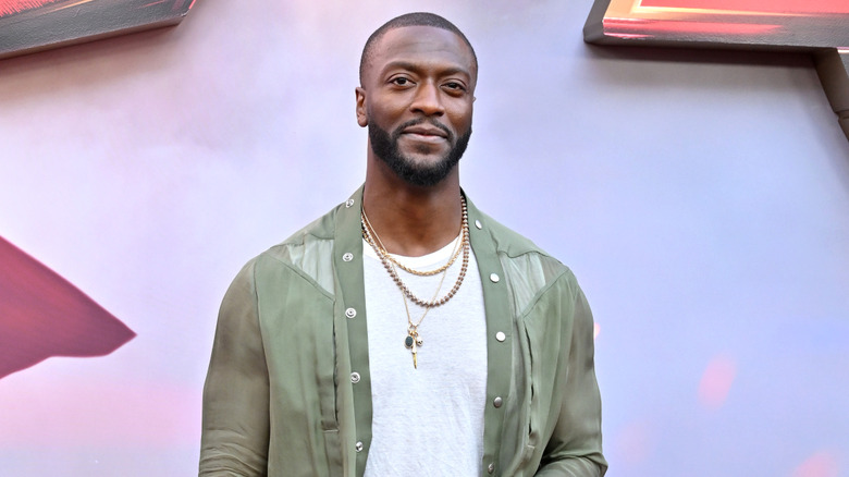 Aldis Hodge in green shirt