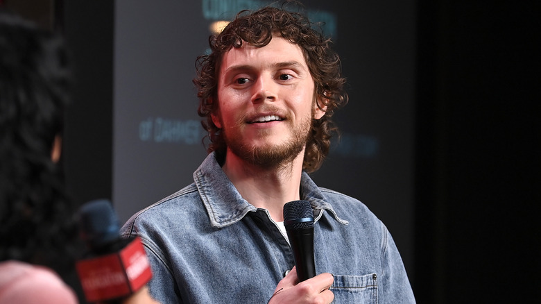 Evan Peters holding microphone