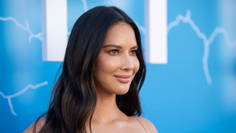 Olivia Munn against blue background