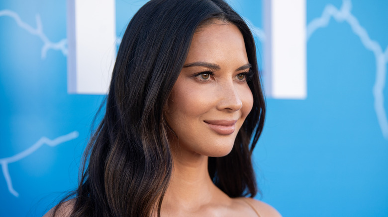 Olivia Munn against blue background