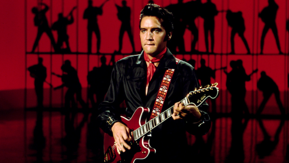 Elvis holding guitar