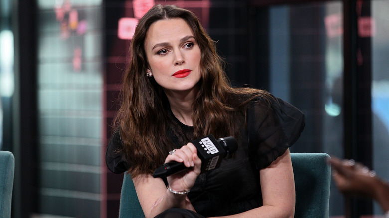 Keira Knightley sitting on stage