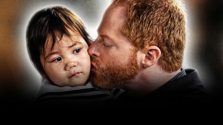 Mitchell kissing baby Lily in "Modern Family"