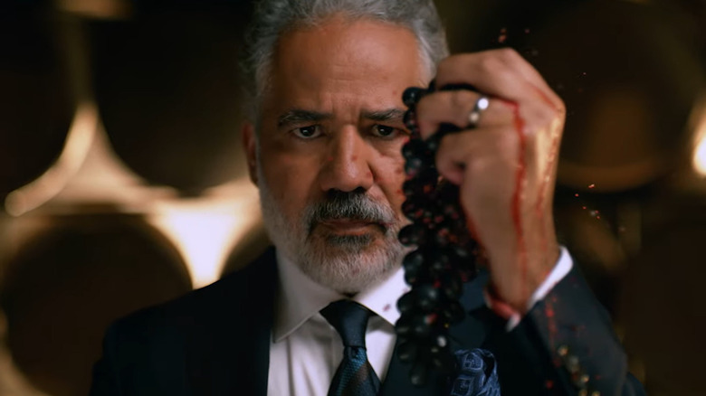 John Ortiz squeezing grapes