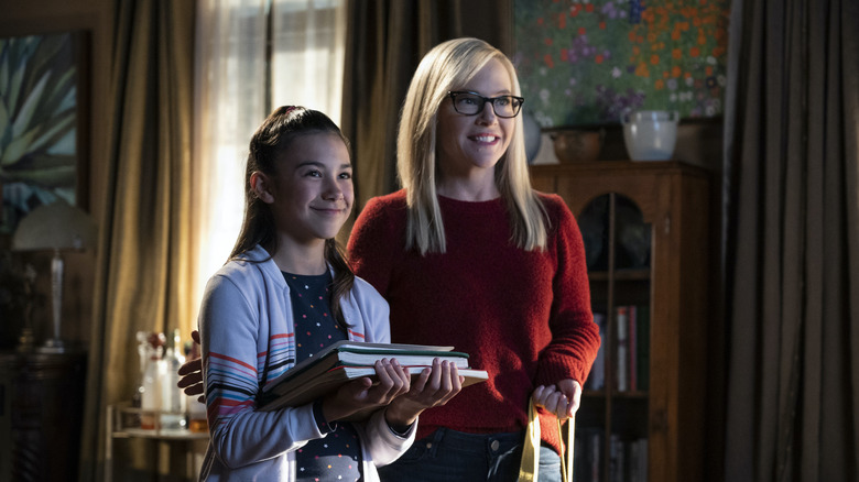 Trixie holding books next to Linda on Lucifer