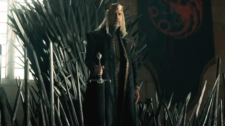 Viserys Targaryen standing in front of Iron Throne