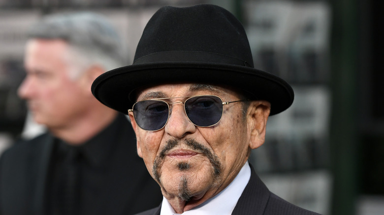 Joe Pesci  in sunglasses and black hat